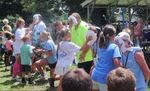children pieing several adults