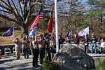 Scouts saluting a flag at a war memorial
