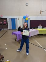 a child holding an award