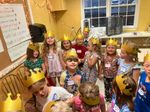a group of children wearing gold paper crowns