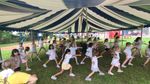 Children under a tent practicing cheerleading