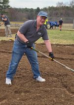 a man raking dirt