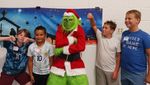 children taunting someone in a "Grinch" costume