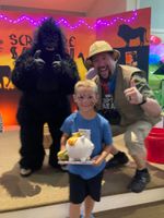 Two men giving a prize to a child