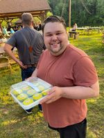 a man holding a box and smiling