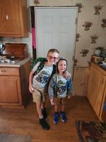 two children posing in a kitchen