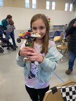 a child holding a LEGO car