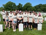 a group of students in a field of white headstones