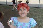 a girl posing with a silver-colored plastic egg