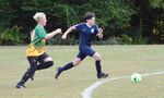 two children playing soccer