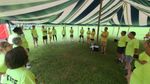Adults in a circle under the tent