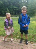 two children posing in a field