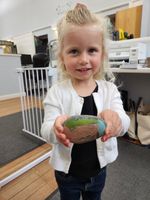 child posing with painted rock