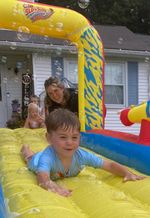 a child riding on a water slide
