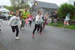 children run down a road