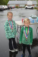 two children with medals pose
