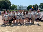 a group of students posing in front of the White House