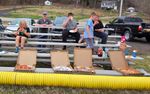 people eating pizza on bleachers