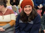 a woman wearing a knit hat shaped like a cupcake