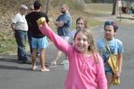 a girl holding up a golden-colored plastic egg