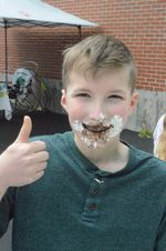 a boy posing with pie filling on his face