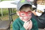 a child posing with Spider-man face paint