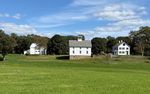 white farm buildings in a field