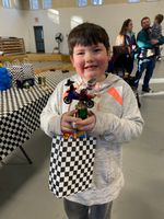 a child holding a LEGO car