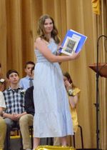 a student posing with a diploma and certificats