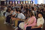 a large group of people watching a screen