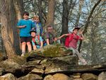 several children climbing on rocks