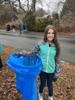 a child posing with a trash bag