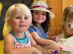 Children playing at a craft table
