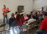 a man speaking to a group of children
