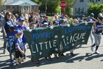 children marching with a banner