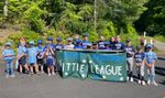 children in baseball uniforms with a sign that says "Pomfret Eastford Little League"