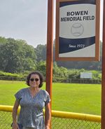 a women standing in front of the sign