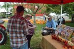 people talking at a book table