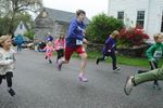 children run down a road