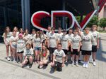 a group of students in front of a large sign that says "SPY"