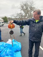 a man holding a pumpkin wind chime