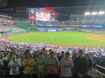 a group of students at a night baseball game