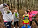 children holding pieces of trash