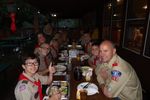 scouts and leaders eating at a long table