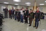 a group of people with their right hands raised
