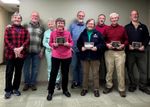 several people, four holding awards