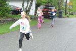 children run down a road
