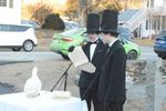 two boys in top hats read a speecch