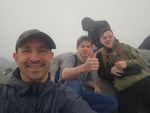people posing for a picture in rain