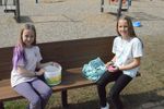 two girls with buckets of eggs